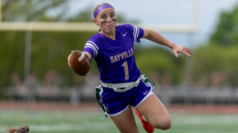 Olivia Moynihan of Sayville extends for extra yards during the Suffolk Class...
