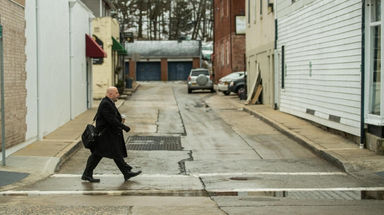 Eric Alexander, executive director of Vision Long Island, walks to work...