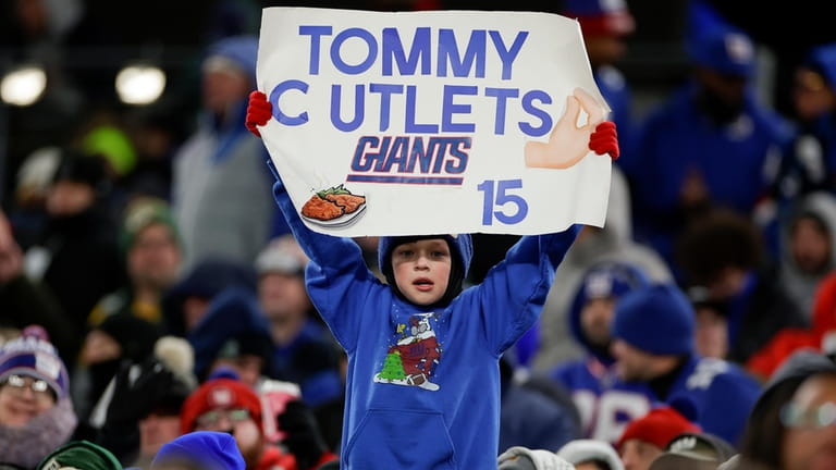 A Giants fan holds up a sign in support of quarterback...
