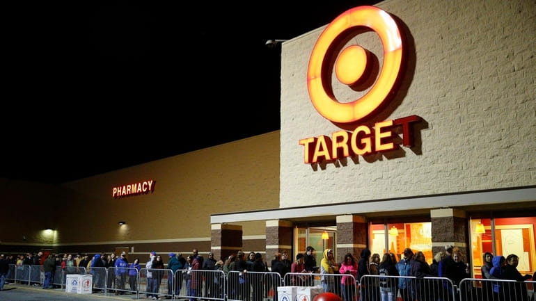 Shoppers wait outside a Target store in Queensbury, New York...