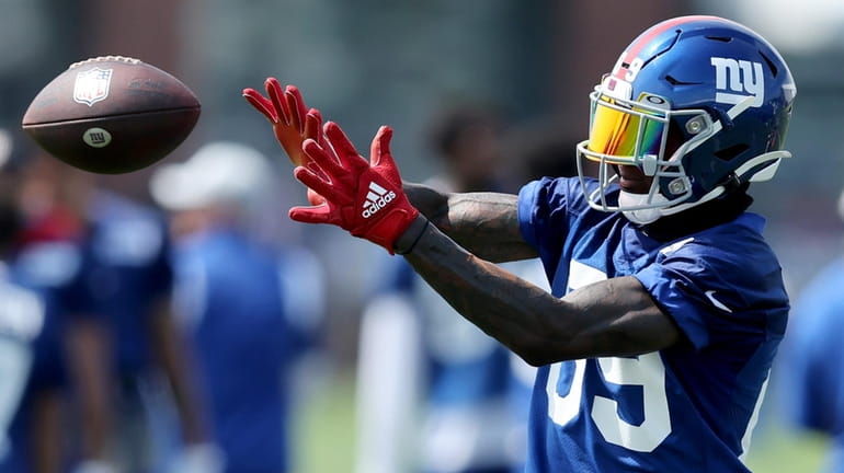 Giants wide receiver Kadarius Toney (catches a pass during training...