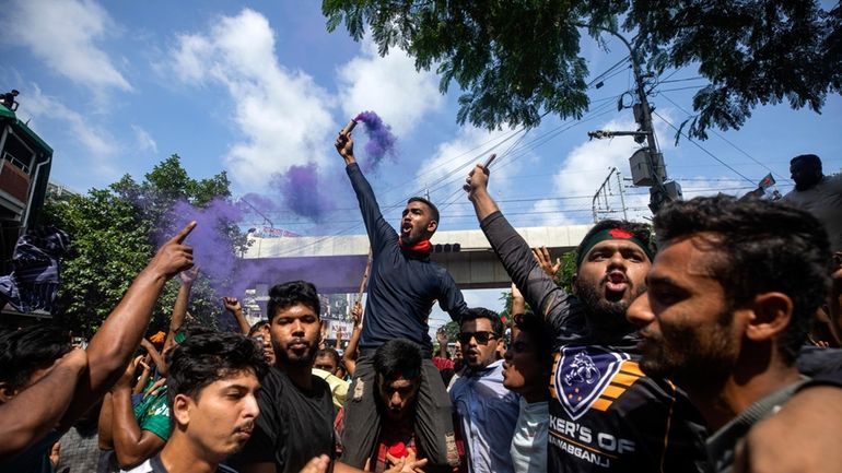 Protesters on Monday in Dhaka, Bangladesh, shout slogans as they...