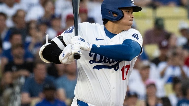 Los Angeles Dodgers' Shohei Ohtani bats during the first inning...