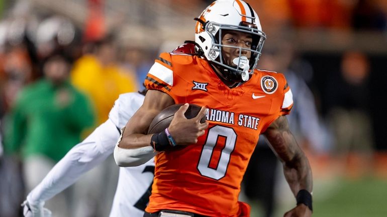 Oklahoma State running back Ollie Gordon II (0) runs for...