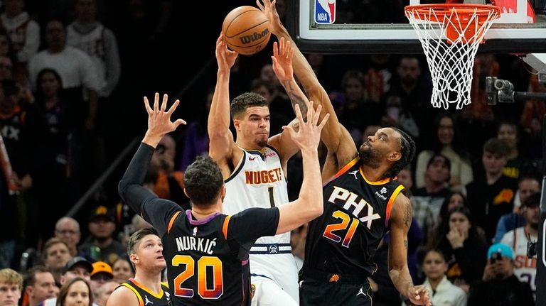 Denver Nuggets forward Michael Porter Jr. (1) passes as Phoenix...