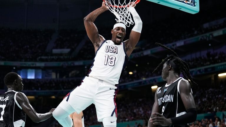 Bam Adebayo, of the United States, reacts after a dunk...