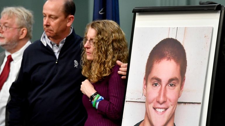 FILE – Jim and Evelyn Piazza, center, stand by as...