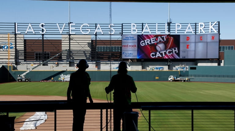 Workers continue construction on a new baseball park in Las...