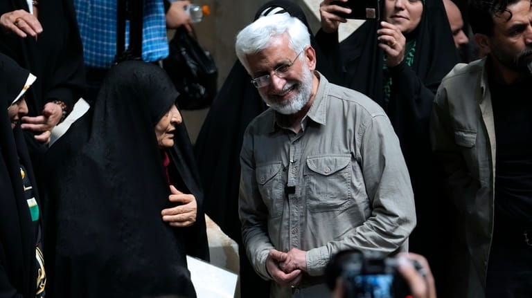 Iranian presidential candidate Saeed Jalili, right, a hard-line former nuclear...