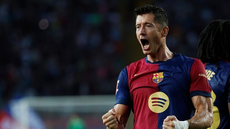 Barcelona's Robert Lewandowski celebrates after scoring his side's second goal...