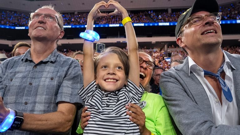 Ashbey Beasley holds up her son Beau, 8, both of...