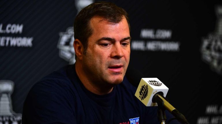 Rangers head coach Alain Vigneault listens to a reporter's question...