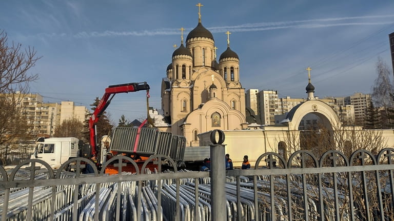 A crane unload police barrier at the Church of the...