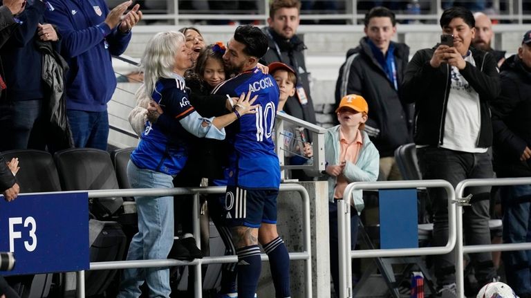 FC Cincinnati midfielder Luciano Acosta (10) celebrates with his family...