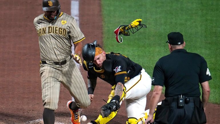 San Diego Padres' Xander Bogaerts, left, knocks the ball out...