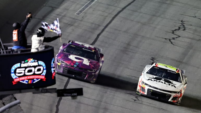 William Byron, right, takes the checkered flag just ahead of...