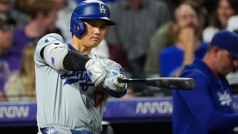 Los Angeles Dodgers' Shohei Ohtani takes a swing before stepping...