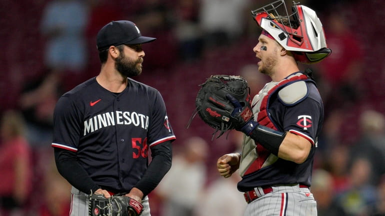 Minnesota Twins relief pitcher Dylan Floro (58) celebrates with catcher...