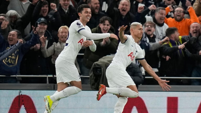 Tottenham's Richarlison, right, celebrates after he scores his side's second...