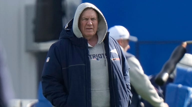 New England Patriots head coach Bill Belichick walks on the...