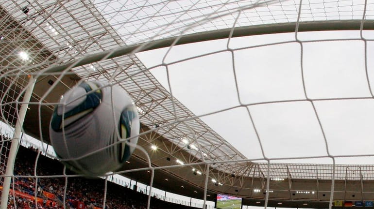 A file photo of a soccer ball hitting the net.