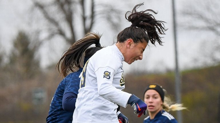 Smithtown West's Sophia Campites, left, goes up to head the...