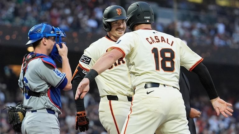 San Francisco Giants' Mike Yastrzemski, middle, celebrates after hitting a...