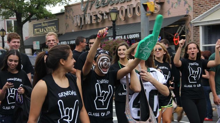 Harborfields High School seniors march down Broadway in Greenlawn during...