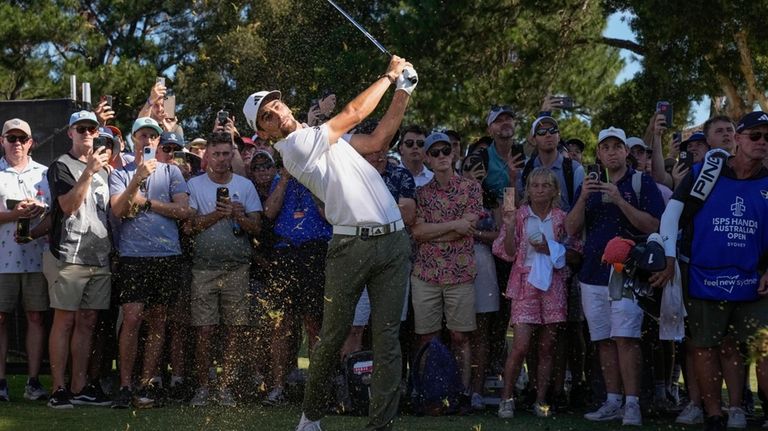 Chile's Joaquin Niemann hits from the rough win the 18th...