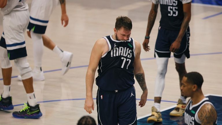 Dallas Mavericks guard Luka Doncic (77) walks off the court...