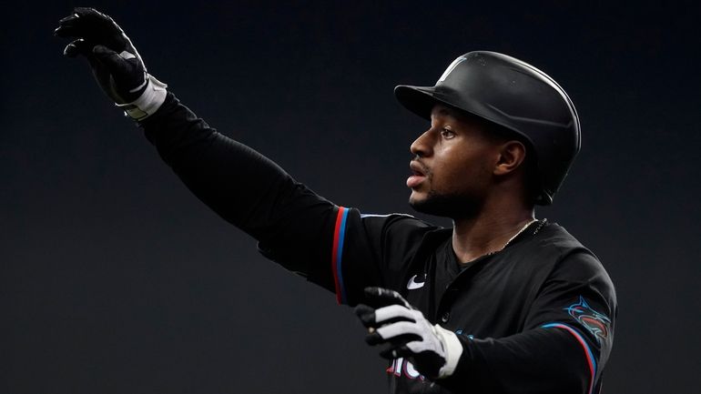 Miami Marlins' Xavier Edwards gestures after hitting a single during...