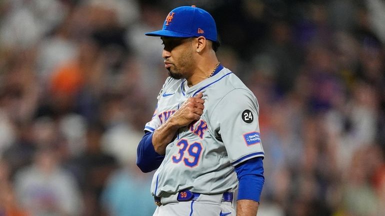 Mets pitcher Edwin Díaz reacts after striking out the Rockies'...