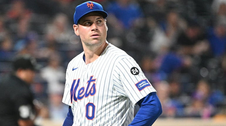 New York Mets relief pitcher Adam Ottavino walks to the...