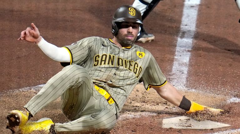 San Diego Padres' Tyler Wade scores the second of two...