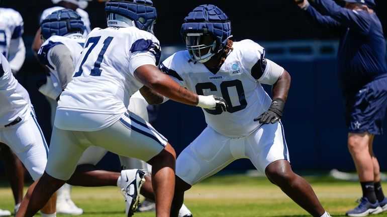 Dallas Cowboys offensive tackle Tyler Guyton, right, and guard Chuma...