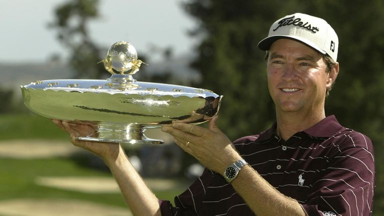 Davis Love III holds the trophy after winning the International...