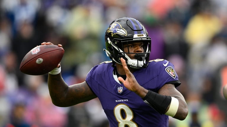 Baltimore Ravens quarterback Lamar Jackson throws during the second half...