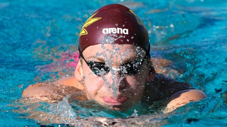 French Olympic swimmer Leon Marchand trains with his Arizona State...