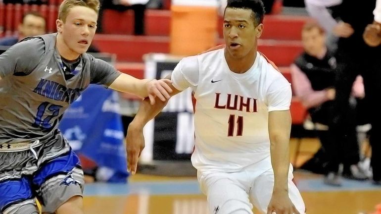 Devonte Green of Long Island Lutheran is guarded closely by...