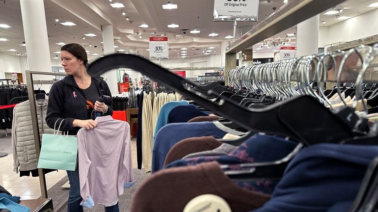 A woman shops at a retail store in Schaumburg, Ill.,...