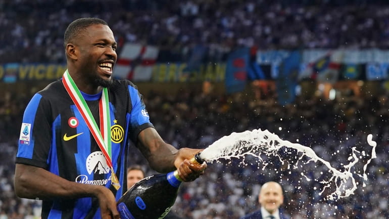 Inter's Marcus Thuram celebrates their victory of the "scudetto" after...
