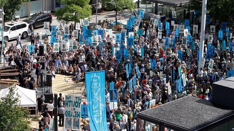 Supporters attend a rally for a group of young people...