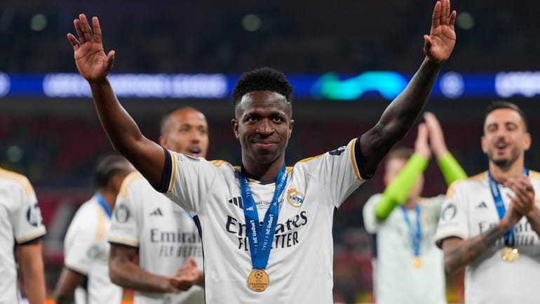 Real Madrid's Vinicius Junior waves after winning the Champions League...