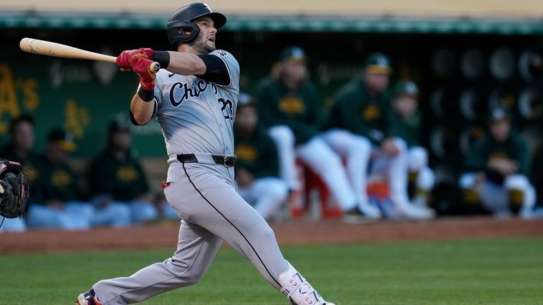 Chicago White Sox's Andrew Benintendi watches his two-run home run...