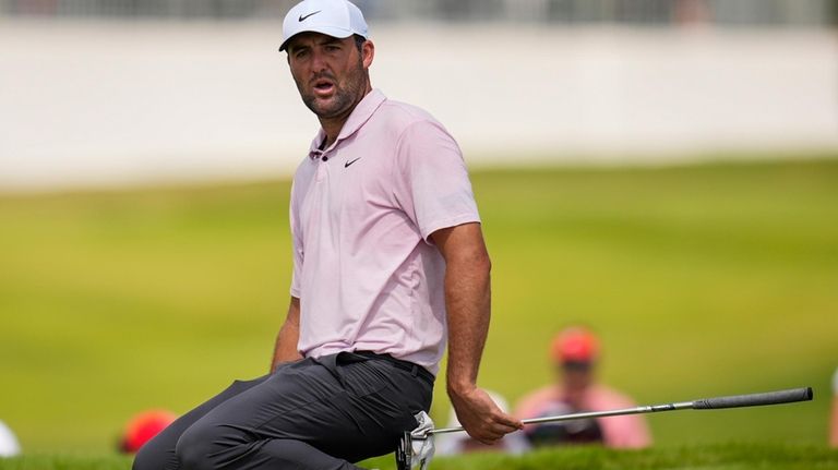 Scottie Scheffler reacts to a missed putt on the fifth...