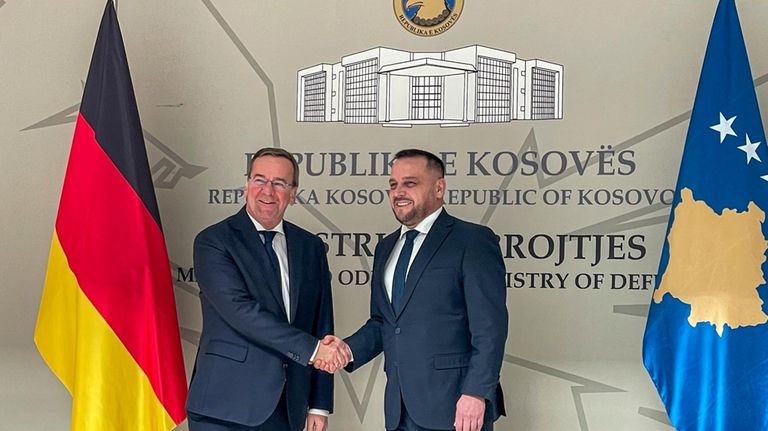 German Defense Minister Boris Pistorius, left, shakes hands with Kosovo's...