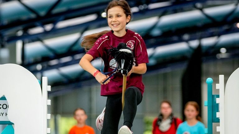 A girl clears the bar during the first German Hobby...