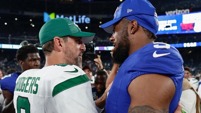 New York Jets quarterback Aaron Rodgers  greets New York Giants...