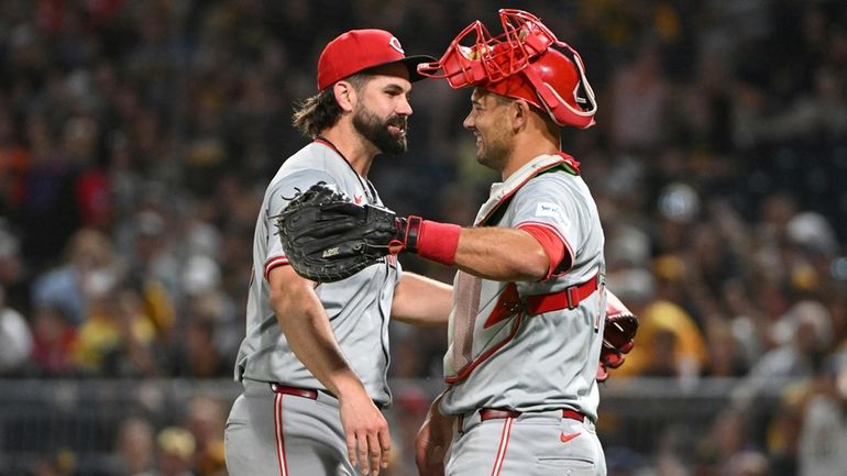 Cincinnati Reds relief pitcher Casey Kelly celebrates with catcher Luke...