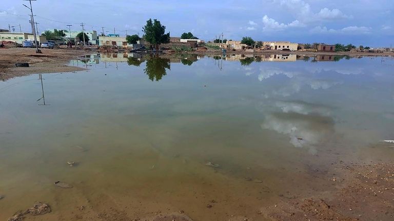 Floodwaters spread across a valley near the city of Abu...